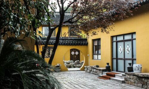 photo of yellow and gray house near trees