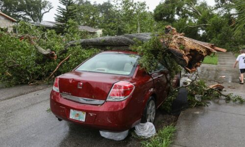 red car parked on gray concrete road
